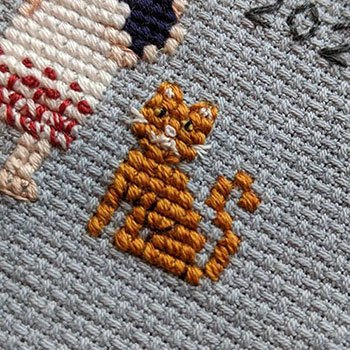 Cute little tabby cat in cross-stitch form