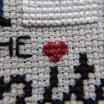 Tiny little red cross-stitched heart