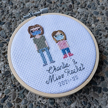 Miss Rachel and Charlie, both cross-stitched wearing face masks in a stitch people style.