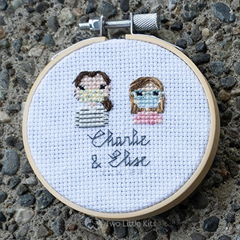 Elise and Charlie, both cross-stitched wearing face masks in a stitch people style.
