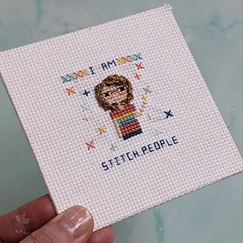 A square stitched self portrait that says 