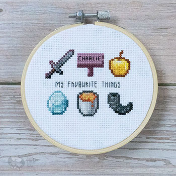 A photograph of a cross-stitched series of icons from the game 'Minecraft'. There are six icons in total and in the middie it says 'My favourite things'.