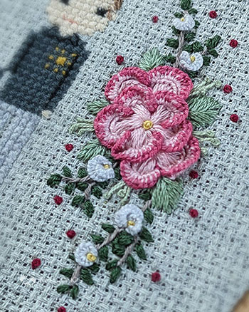 A close-up photograph of hand embroidered flowers in a different style than before. These ones are lighter in colour, more gentle in style and much more polished in look.