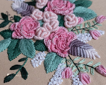Super close-up photo of the hand embroidered flowers.