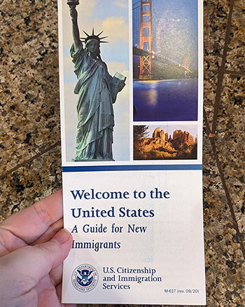 A photo of a brochure from USCIS that says 'Welcome to the United States - A Guide for New Immigrants'.