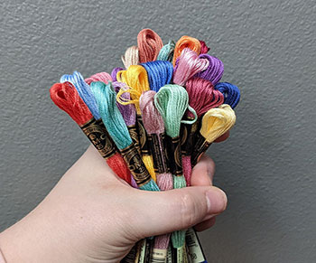 A photo of a hand holding a 'fistful' of flosses 