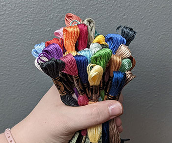 A photo of a hand holding a 'hoard' of flosses 
